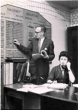 Photo:Medical records officer checking the number of available beds, Apr 1962 (Catalogue reference: SBHH-PG-116).